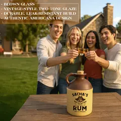 Personalized ceramic rum jug with pirate-themed skull and crossed swords design labeled ‘Sacha’s Rum,’ displayed on an outdoor wooden table as friends toast in the background; unique custom drinkware gift and rustic home bar accent for themed parties