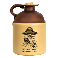 Alien-abduction stoneware moonshine jug featuring a UFO beaming up a moonshiner with the caption “They Only Want Our Good Stuff,” shown against a white background.