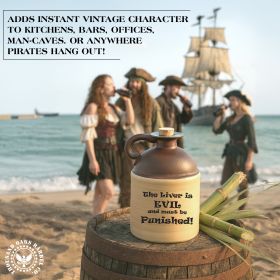 Rustic ceramic moonshine jug with brown top and humorous text ‘The liver is evil and must be punished,’ displayed on a beach barrel with pirate reenactors in the background; unique novelty drinkware and humorous barware gift