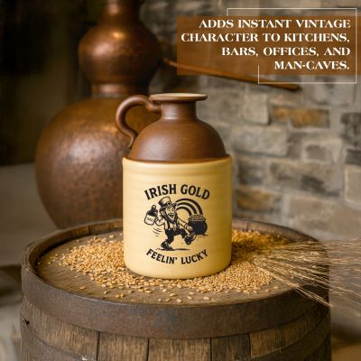 Irish Gold “Feelin’ Lucky” stoneware moonshine jug displayed on a whiskey barrel with grain and a copper still in the background, showcasing vintage Irish-themed bar décor.
